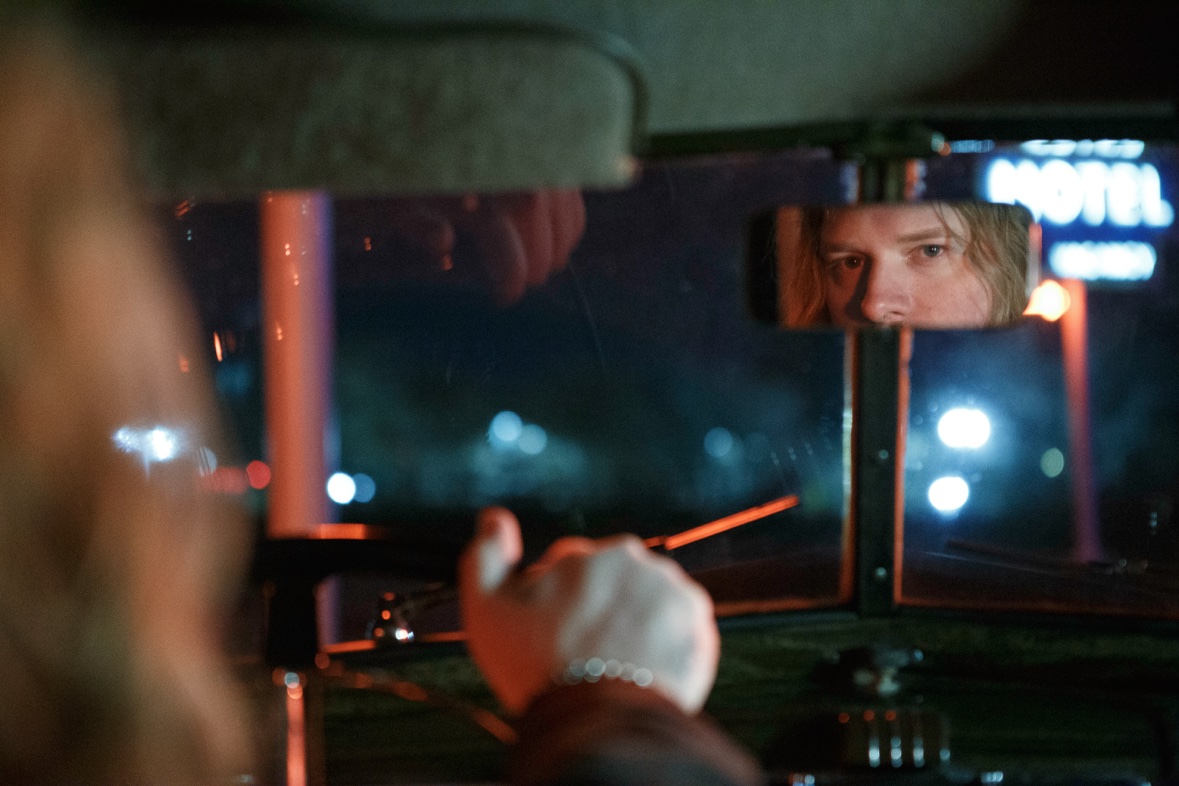 Micheal Sawyer reflected in a rear-view mirror at night